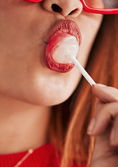 Image showing Lollipop, woman mouth and closeup with makeup, cosmetics and gen z style eating a sweet candy. Lips, young person and hungry female model with sweets and modern fashion and youth aesthetic close up