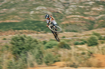 Image showing Cycling, jump and mountain bike with man in nature for extreme sports, fitness and adventure. Adrenaline junkie, performance and stunt with athlete riding in outdoors for action, risk and training