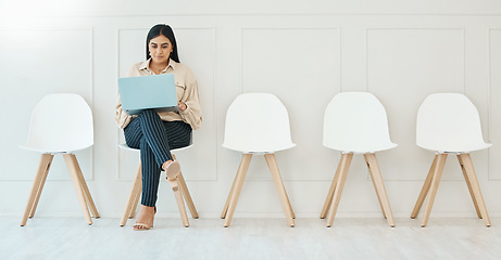 Image showing Waiting room, sitting and a woman with a laptop for business, email and interview research. Office, working and corporate employee with a computer for the internet, recruitment planning and browsing