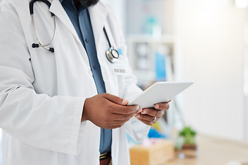 Image showing Black man, doctor and hands with tablet in healthcare research, planning or checking schedule appointment at hospital. Hand of African male medical expert working, browsing or search on touchscreen