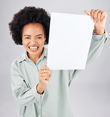 Image showing Portrait, poster and mockup with a woman holding blank paper in studio on a gray background for branding. Marketing, smile or product placement with a happy young afro female showing advertising copy