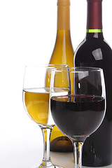 Image showing Two wine bottles with glasses