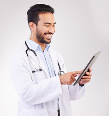 Image showing Happy asian man, doctor and tablet in medical research, Telehealth or communication against a white studio background. Male healthcare professional smiling on touchscreen for good health results