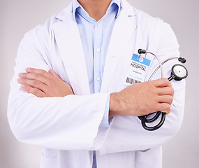 Image showing Arms crossed, stethoscope and man doctor in studio for healthcare, examination or check up on grey background. Hands, cardiovascular or health by medical expert ready for consultation, exam or help