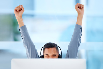 Image showing Happy, success and a man in call center with a win, celebration and target achievement on a pc. Smile, excited and a customer support agent celebrating a promotion, bonus or telemarketing goal