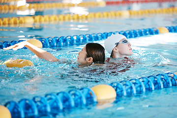 Image showing Saving, swimming and a lifeguard with a woman in a pool after drowning. Rescue, support and a professional helping a girl to safety after an accident, emergency or danger in the water for a swim