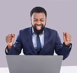 Image showing Laptop, celebration and black man in business, studio or achievement of target, goals or motivation. Happy male worker, computer or celebrate success of winner, bonus or fist of winning surprise deal