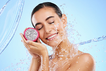 Image showing Dragon fruit, water or happy woman with beauty in studio on blue background for healthcare or vegan diet. Smile, wellness or healthy girl model face with fruits or vitamin c for skincare or detox