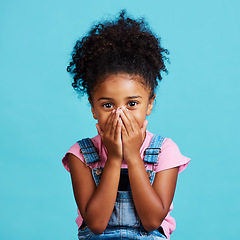 Image showing Children, portrait and wow with a girl on a blue background in studio looking surprised or in shock. Face, hands and gossip with a cute little female child reacting to good news or an announcement