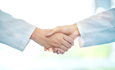 Image showing Doctor, handshake and meeting in partnership for deal, b2b or agreement in healthcare collaboration at the hospital. Medical team shaking hands in teamwork support, hiring or promotion at the clinic