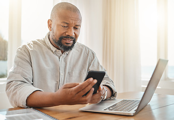 Image showing Phone, laptop and remote work with a black man checking his debt or banking from the home office. Pension, contact and communication with senior male working on finance in a living room of his house