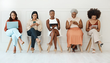 Image showing Business woman, networking and communication in waiting room for social media, career opportunity or job search at office. Employee women busy on multimedia devices for mobile app or network in a row