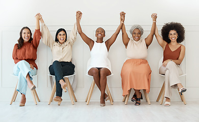 Image showing Happy women, business and teamwork celebration in waiting room for hiring, job opportunity or success at office. Group of woman employees holding hands in happiness for team win or victory in a row