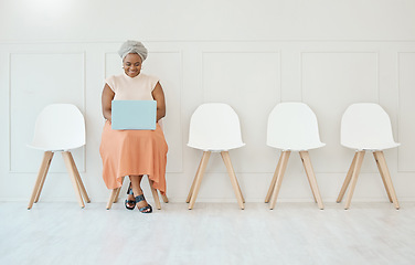 Image showing Happy, recruitment and a black woman in a waiting room with a laptop typing an email. Smile, business and an African corporate employee with a computer for an interview, job search and reading notes