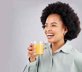 Image showing Thinking, mockup and orange juice with a laughing woman in studio on a gray background for health or vitamin c. Idea, drink and glass with a happy young female drinking a fresh beverage for nutrition