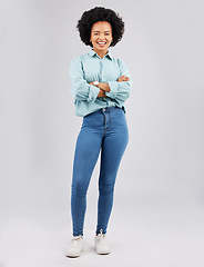 Image showing Fashion, beauty and woman in a studio with a casual, stylish and trendy outfit with a jeans and shirt. Happy, smile and portrait of an African female model with style isolated by a gray background.