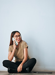 Image showing Phone call, floor and happy woman talking in home by wall background with mockup. Cellphone, thinking and person smile while sitting on ground, discussion or conversation, chatting or speaking online