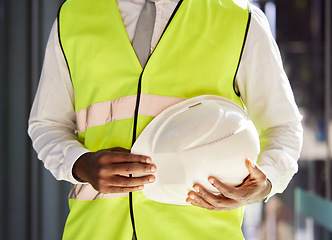 Image showing Property development, architect and hands with a safety helmet for construction and engineering. Building, black man and business developer ready for real estate and infrastructure renovation
