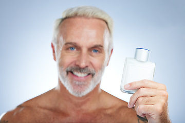 Image showing Old man, cologne aftershave and portrait in a studio with perfume and spray bottle product with a smile. Isolated, grey background and happiness of a senior and elderly model with beauty routine