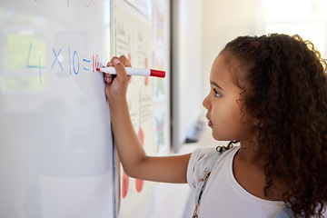 Image showing Whiteboard, math and girl writing for learning, studying and education in classroom. Development, mathematics and kid or student write equations, numbers and multiplication in elementary school.