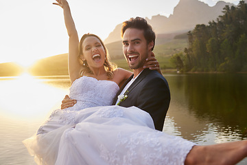 Image showing Wedding, lake and groom carrying bride in nature and water with passion, smile and romance. Marriage, excited happy couple celebrate love and romantic relationship, loving man and woman together.