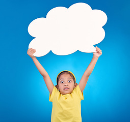 Image showing Speech bubble, surprise and portrait of child in shock for news, opinion and announcement on blue background. Talking, social media mockup and wow, omg and excited girl with poster board in studio