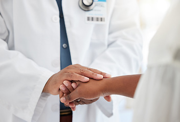 Image showing Healthcare, hands and doctor comforting a patient after a diagnosis at a consultation in the hospital. Wellness, compassion and male medical worker with empathy for a woman in a medicare clinic.