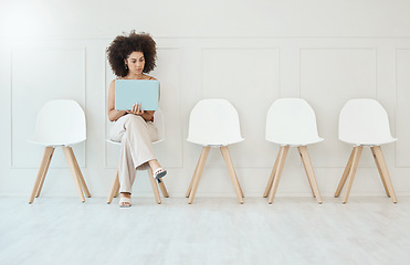 Image showing Recruitment, laptop and woman in waiting room for interview, hiring or job opportunity in office. Computer, hr and business person typing online while sitting on chair for employment in workplace.