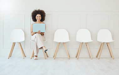 Image showing Portrait, laptop and woman in waiting room, interview or recruitment, hiring or job opportunity. Computer, hr and happiness of business person or mixed race female sitting on chair for employment.