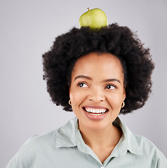 Image showing Thinking, apple on head and black woman with smile, health and nutrition against a grey studio background. African American female, fruit and happy lady with happiness, diet and wellness with ideas