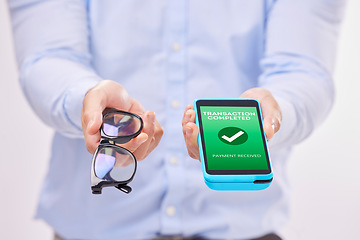 Image showing Man, hands and phone with transaction approval or glasses for ecommerce or purchase against a white studio background. Hand of male holding spectacles and mobile smartphone for electronic payment