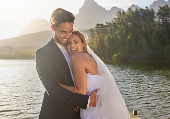 Image showing Happy, hug and couple at a lake wedding with love at a ceremony, celebration and marriage. Smile, affection and a man and woman hugging after romantic relationship commitment in nature together