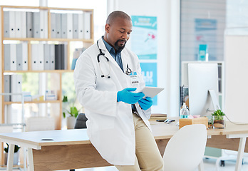 Image showing Black man, doctor and tablet in healthcare research, planning or checking schedule appointment at hospital. Happy African male medical professional working and browsing on touchscreen for Telehealth