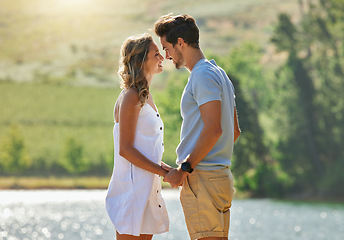 Image showing Couple holding hands, relax by lake and summer, travel and adventure with love and care outdoor. People in relationship, trust and bonding on vacation, man and woman with happiness and freedom