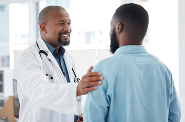 Image showing Doctor, black man and touch shoulder of patient for support, comfort and empathy in hospital. Healthcare, consultation and happy medical professional talking, good news or kindness with mature person