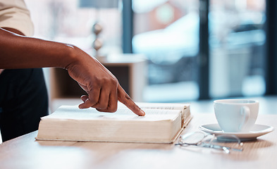 Image showing Hand, bible and a person reading in a cafe for religion, belief or faith in god and jesus. Education, learning and pointing with an adult in a coffee shop to study for spiritual knowledge in christ