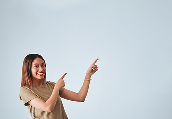 Image showing Woman, pointing hands and smile at space for mockup, studio advertising or product placement. Happy female on white background to show logo or branding with discount, promotion or sale announcement