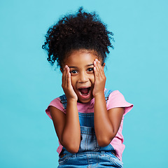 Image showing Wow, expression and portrait of a child with shock isolated on a blue background in a studio. Happy, cute and face of a little girl with surprise, good news reaction and amazement on a backdrop