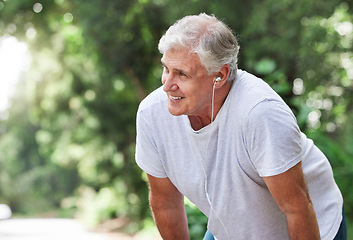 Image showing Senior man, tired and outdoor with music earphones for run, workout and training on road for fitness. Elderly male person happy about cardio exercise for health and wellness on running, rest or break