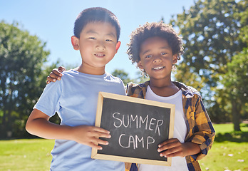 Image showing Summer camp, portrait or boys hugging in park together for fun bonding, development or playing in outdoors. Happy young best friends smiling or embracing on school holidays outside with board sign