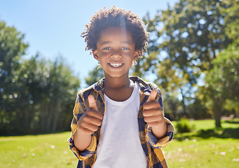 Image showing Happy child, portrait or boy with thumbs up in park for a fun activity or playing in nature or summer. Excited young African kid smiling on holiday outside with success, happiness or achievement