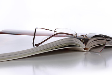 Image showing Open book with glasses