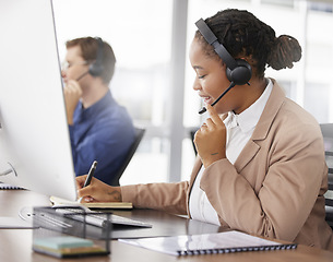 Image showing Black woman, call center and writing notes, smile in office and working on customer service in workplace. Telemarketing, notebook and happy person, female sales agent or consultant talking online.