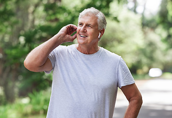 Image showing Thinking, music and man with earphones while running, fitness motivation and exercise audio. Ready, smile and a senior person laughing while listening to a podcast at a park for cardio and workout