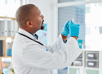 Image showing Doctor, syringe and healthcare vaccination, injection or medicine for cure, pain or illness at hospital. Black man, medical professional holding filled needle for wellness or antibiotic at clinic