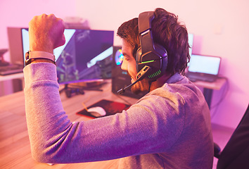 Image showing Winner, fist and man on computer with microphone, celebrating game win and success. Happy male gamer, cheering or esport player celebration for online competition, excited for progress or achievement