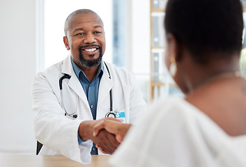 Image showing Happy doctor, patient and handshake in healthcare visit, consultation or agreement at hospital. Black man, medical professional shaking hands with woman client for consulting, checkup or appointment