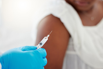 Image showing Hand, covid vaccination and a patient with her doctor in the hospital for an injection of medicine or antibiotics. Healthcare, medical and consulting with a healthcare professional holding a syringe
