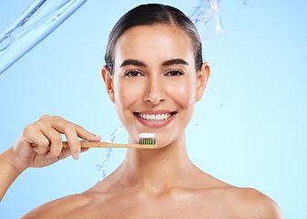 Image showing Portrait, water or happy woman brushing teeth smiling with product for healthy oral or dental hygiene in studio. Face, smile beauty or girl model cleaning mouth with natural bamboo wooden toothbrush