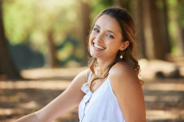 Image showing Nature, happy and portrait of a woman in a forest on an outdoor adventure, explore or travel. Happiness, smile and face of a young female model posing in the woods with a positive mindset in summer.